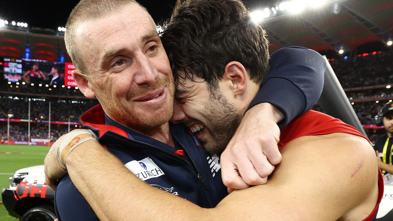 Simon Goodwin hugs Christian Petracca after winning last year’s grand final. Picture: Michael Klein