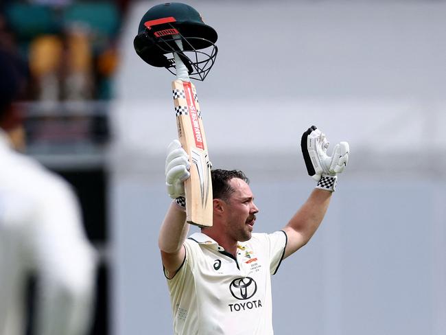 Travis Head celebrates reaching his century in trademark style. Picture: David Gray / AFP