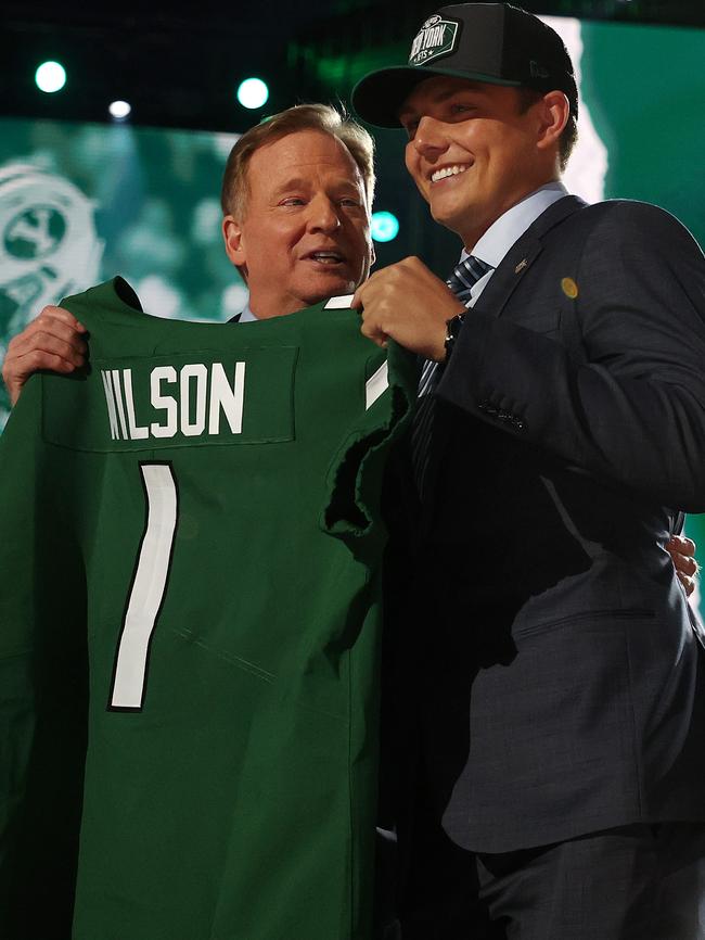 Zach Wilson stands onstage with NFL Commissioner Roger Goodell after being drafted second by the New York Jets.