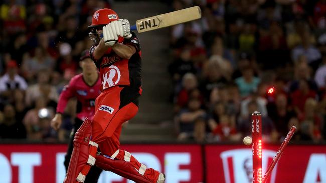 The Renegades’ Tim Ludeman is castled by Sydney’s Tom Curran. Picture: AAP