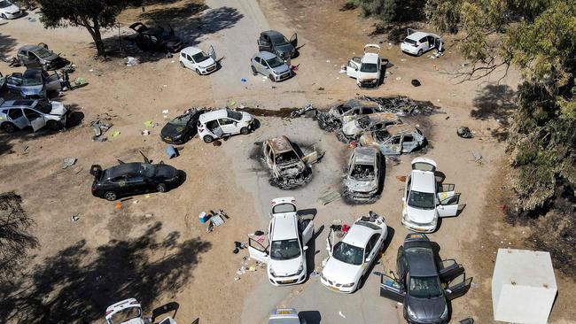 Abandoned and torched vehicles at the site of the October 7 attack by Palestinian militants near Kibbutz Reim in the Negev desert in southern Israel. Picture: Jack Guez/AFP