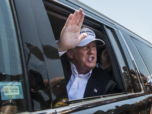 LAREDO, TEXAS - JULY 23: Republican Presidential candidate and business mogul Donald Trump talks to media from his car wearing a, "Make America Great Again," hat during his trip to the border on July 23, 2015 in Laredo, Texas. Trump's recent comments, calling some immigrants from Mexico as drug traffickers and rapists, have stirred up reactions on both sides of the aisle. Although fellow Republican presidential candidate Rick Perry has denounced Trump's comments and his campaign in general, U.S. Senator from Texas Ted-Cruz has so far refused to bash his fellow Republican nominee. (Photo by Matthew Busch/Getty Images)