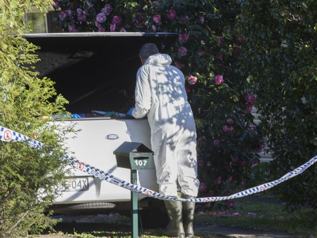 A man removed cleaning items at the house following the murders. Picture Jenny Evans