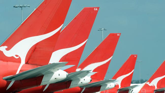 The tails of Qantas jets are seen at Sydney International Airport, Wednesday, Dec. 3, 2008. Qantas announced today, Tuesday, April 14, 2009 that more than 1500 jobs could go as it reduces capacity in the face of rapidly deteriorating trading conditions. The airline also slashed its full year pre-tax profit outlook to between $100 million and $200 million, down from its previous forecast of $500 million. (AAP Image/FILE/Dean Lewins) NO ARCHIVING