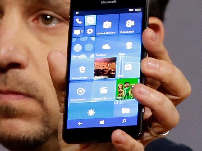 Microsoft vice president for Surface Computing Panos Panay shows a new Lumia 950 phone during a presentation, in New York, Tuesday, Oct. 6, 2015. The device will work with an optional dock. Users can attach a regular monitor, keyboard and mouse and work with apps on the phone just like you would on a Windows 10 desktop. (AP Photo/Richard Drew)