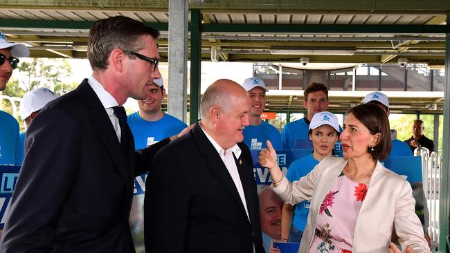 NSW Treasurer Dominic Perrottet, candidate for Heathcote Lee Evans and Gladys Berejiklian. She Berejiklian visited Engadine train station to remind commuters the maximum weekly Opal cost would be capped at $50.