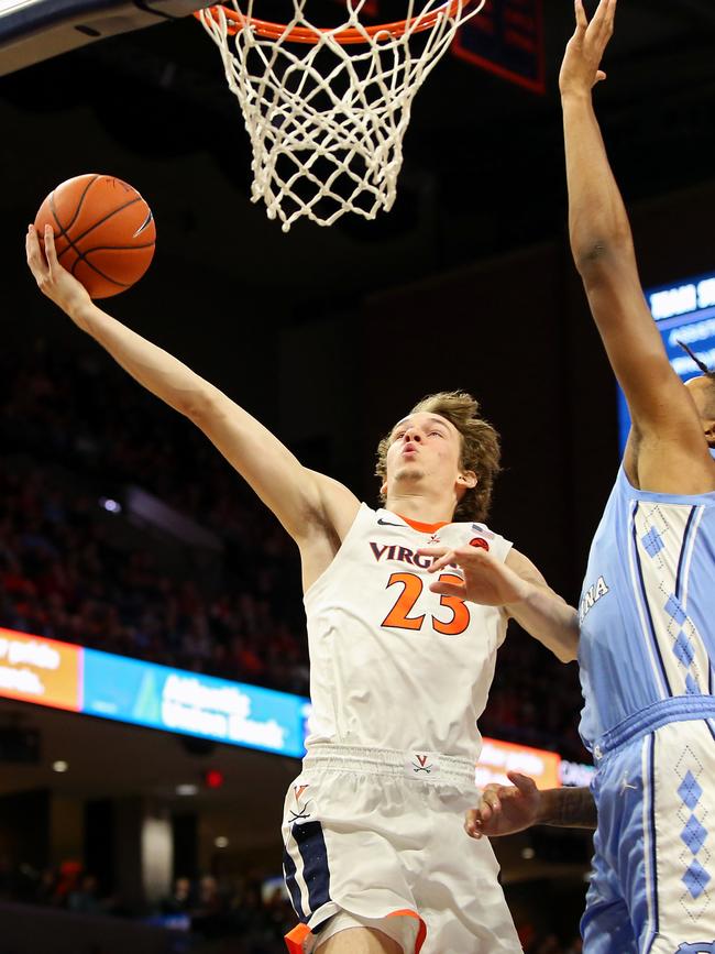 Kody Stattmann #23 of the Virginia Cavaliers shoots past Armando Bacot #5 of the North Carolina Tar Heels in the second half during a game at John Paul Jones Arena on December 7, 2019 in Charlottesville, Virginia. (Photo by Ryan M. Kelly/Getty Images)