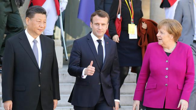 Emmanuel Macron hosts Angela Merkel and Xi Jinping at the Elysee Palace on Tuesday. Picture: AFP