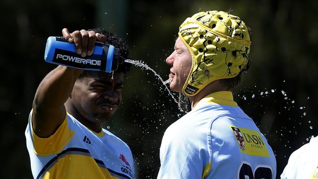 Samuela Sorovi and Douglas Manning from Team Waugh cool off in a drinks break.