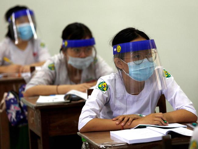 Students wearing masks and face shields attend classes during the first day of reopening of public high schools following closure due to the COVID-19 coronavirus in Yangon. Picture: AFP