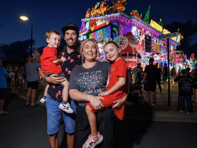 David and Chloe Strickland with their children Noah 3, and Piper 5, at their Burpengary East home covered in Christmas lights. Picture: Lachie Millard