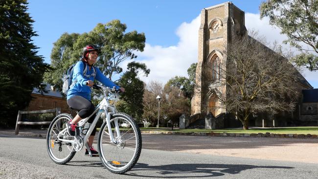 Lynn Cameron cruises past a historic church at Sevenhill. Picture: Russell Millard