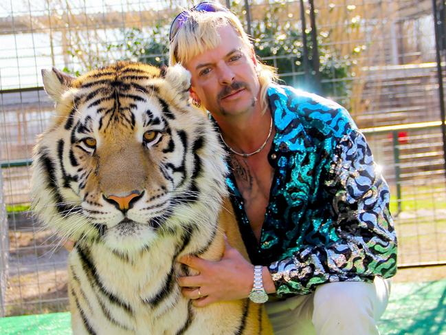 (FILES) In this undated file photo courtesy of Netflix shows Joseph "Joe Exotic" Maldonado-Passage with one of his tigers. - A follow-up to "Tiger King," the documentary series that captivated millions around the world in the early days of the Covid-19 pandemic, will be released this year, Netflix said September 23, 2021. (Photo by - / Netflix US / AFP) / RESTRICTED TO EDITORIAL USE - MANDATORY CREDIT "AFP PHOTO / NETFLIX" - NO MARKETING - NO ADVERTISING CAMPAIGNS - DISTRIBUTED AS A SERVICE TO CLIENTS / TO  GO WITH AFP STORY by Paul HANDLEY, "'Tiger King': true-crime tale of 'Joe Exotic' grips shut-in nation"