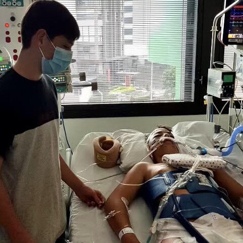 Carlo Medina, 13, in hospital with his twin brother Enrique by his side. Picture: Supplied