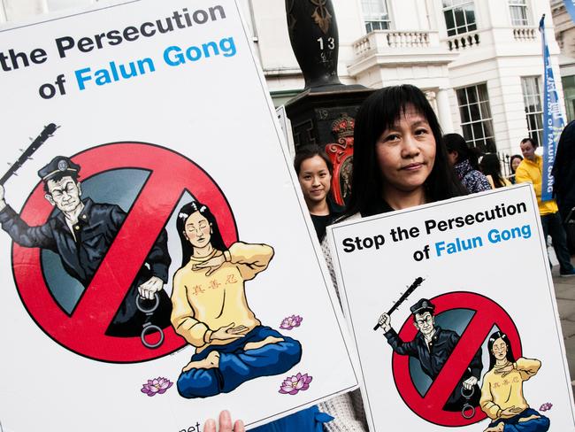 Falun Gong practitioners hold banners during a protest against the Chinese government in London last year. Picture: Noemi Gago/Alamy Live News