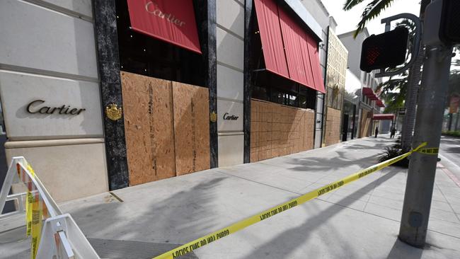 Police tape is seen near a Cartier store on Rodeo Drive, the world renowned shopping street in Beverly Hills, California, which is boarded up and closed to vehicles and pedestrian traffic as a precaution against possible violence on US election day. Picture: Robyn Beck/AFP)