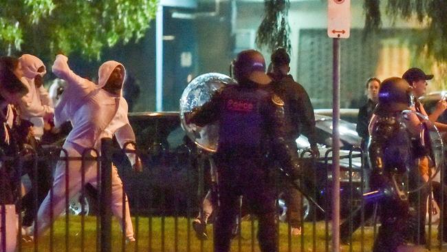 Youths from the nearby commission flats threw rocks and bottles at riot police. Picture: Jake Nowakowski