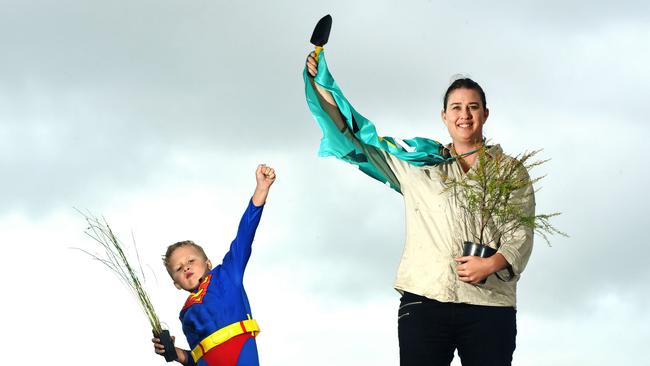 Saraya Robinson and 5 yr Kai dressed as superheroes as they plant trees for community event. Picture: John Gass