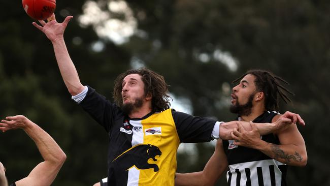 Grattan Stephens of Chirnside Park (left) contests with Jara Oburu of Surrey Park. Photo: Hamish Blair