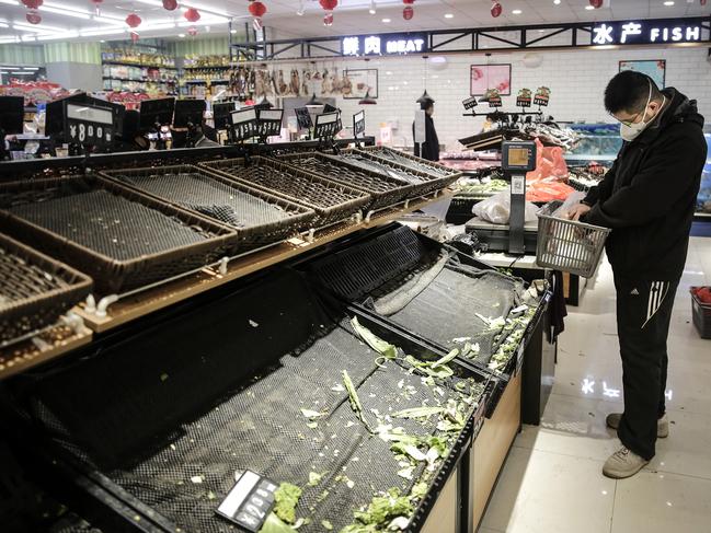 Images obtained from inside Wuhan following the closure showed long lines and empty shelves at supermarkets, as residents stocked up for what could be weeks of relative isolation. Picture: Getty