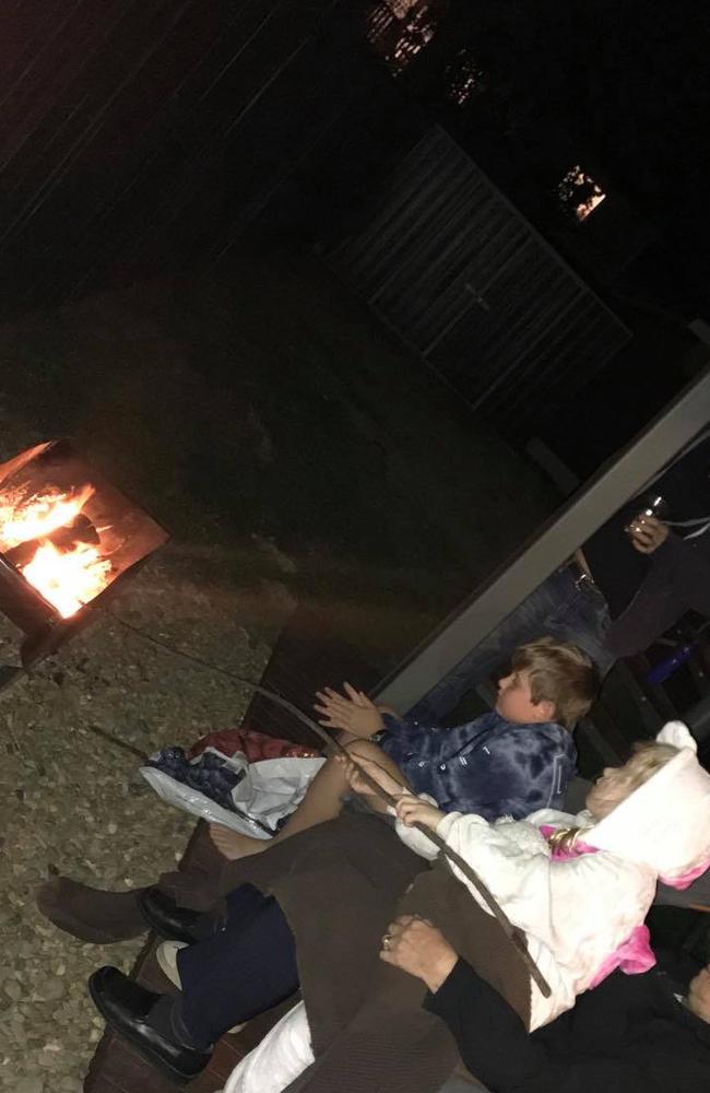 Kirsty George's family toasting marshmallows around their fire pit.