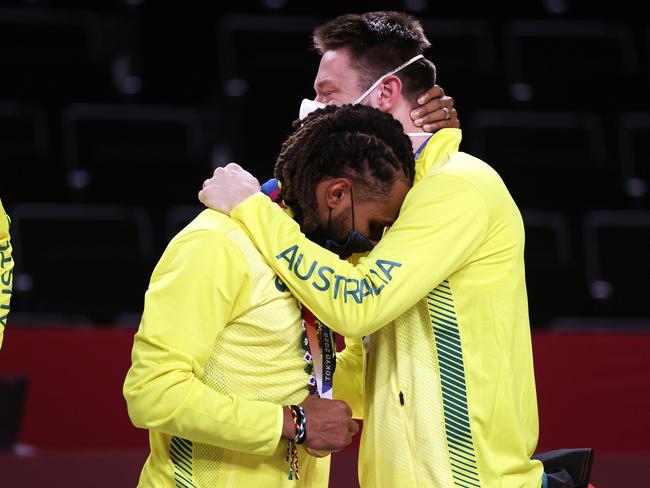 Patty Mills and Matthew Delavedova hug one another during the Men's Basketball medal ceremony.