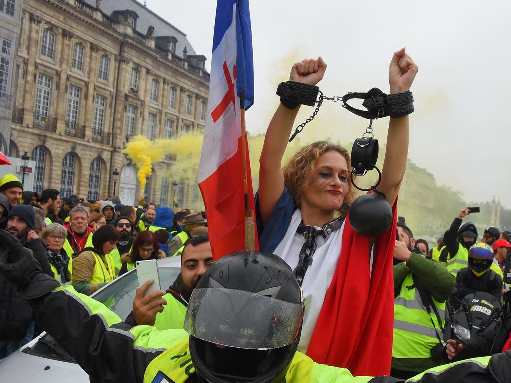 A protester wrapped in a French flag and wearing a ball and chain costume attends during the anti-government protest on December 22, 2018, in Bordeaux. Picture: AFP