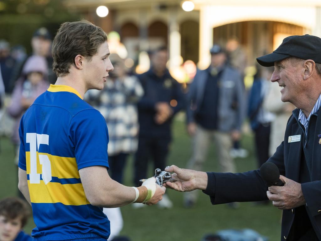 Grammar MVP Richard Dean accepts the trophy from TGS Old Boys Association president Mark Creedon.