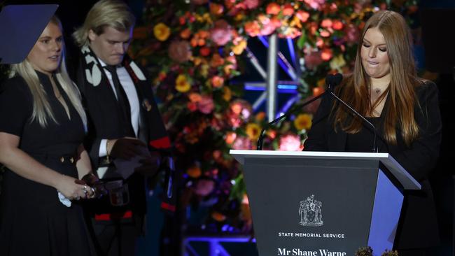 Summer speak the public memorial for her father Shane Warne as siblings Jackson and Brooke watch on. Picture: Michael Klein