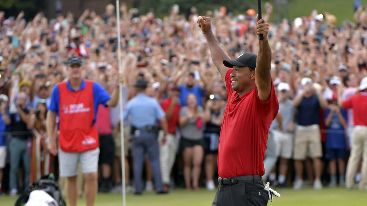 Tiger Woods celebrates after on the 18th green after winning the Tour Championship golf tournament in Atlanta.
