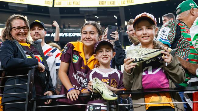 Maddie and Ryatt Jenkins from Varsity Lakes in Queensland, and Lexi Santangelo from Brisbane, with signed boots from Adam Reynolds. Todd Martyn-Jones