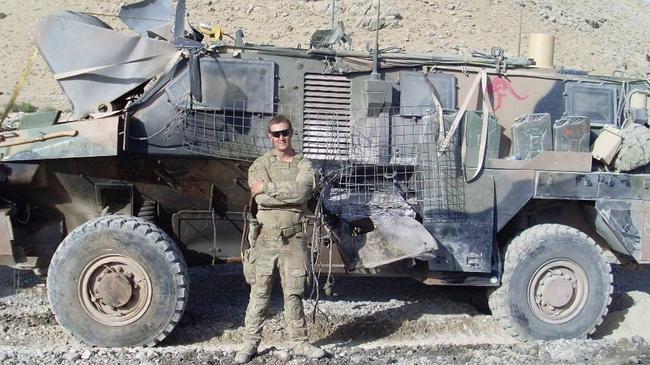 Kane Hall next to his Bushmaster armoured vehicle in Afghanistan in 2011. Picture: Supplied by Kane Hall