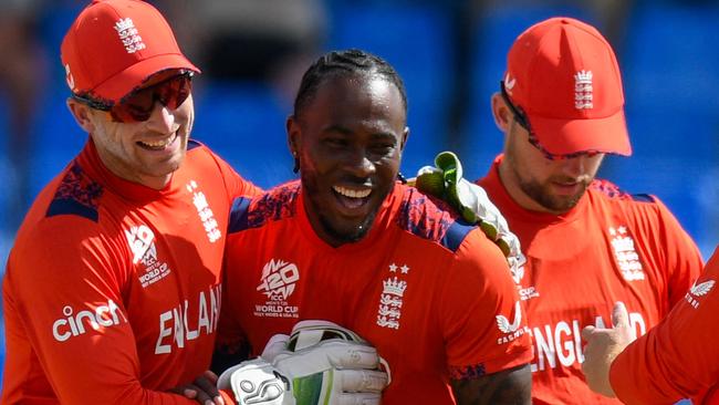 Jofra Archer (2L) and Jos Buttler (L) of England celebrates the dismissal of Pratik Athavale of Oman during the ICC men's Twenty20 World Cup 2024 group B cricket match between England and Oman at Sir Vivian Richards Stadium in North Sound, Antigua and Barbuda, on June 13, 2024. (Photo by Randy Brooks / AFP)