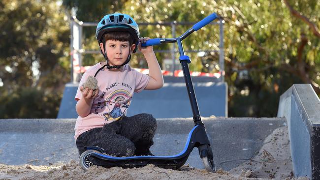 Hugo, 6, with his scooter at the Highett skate park, which is covered in piles of sand but is supposed to reopen on Monday. Picture: Josie Hayden