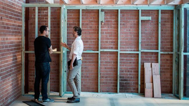 Architect Luke Durack shares some thoughts with a team member after disaster struck. Image: Supplied.