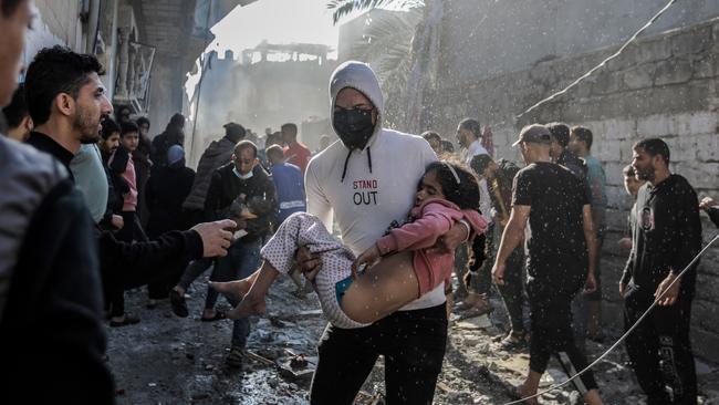 People search through buildings, destroyed during Israeli raids a day earlier, in the southern Gaza Strip in Khan Yunis. Picture: Getty