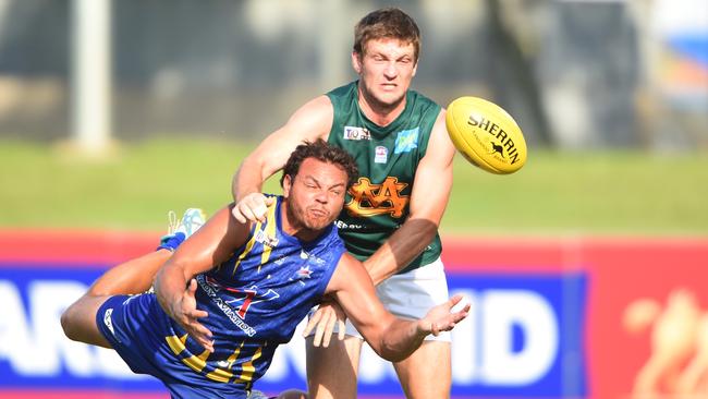 Peter Reichelt (back) playing in the Northern Territory against former North Melbourne player Shannon Motlop.