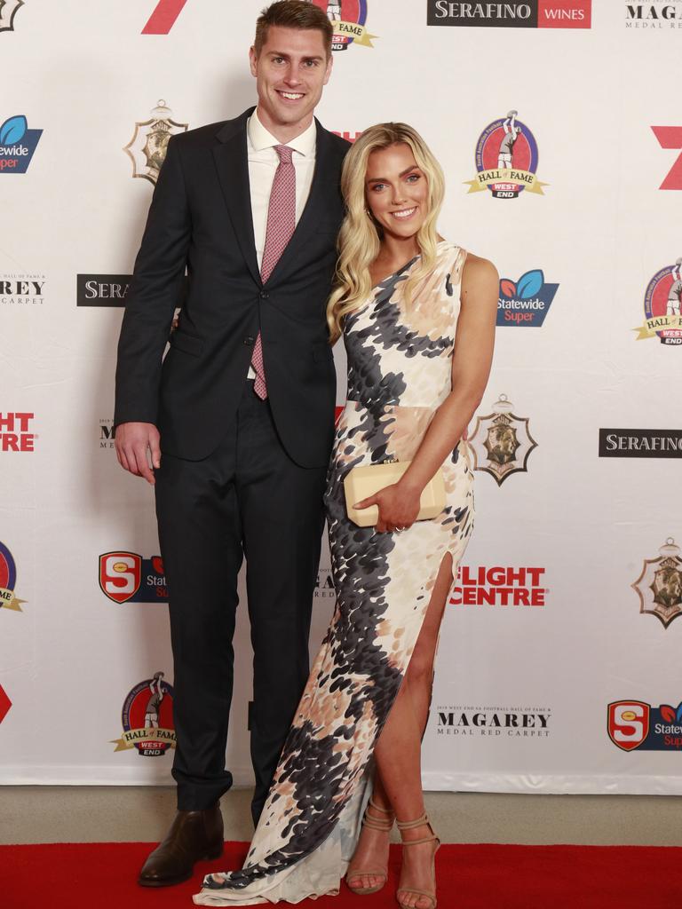 Michael Talia and Nicola Burgess wearing Alexis George pose for a picture on the red carpet at Adelaide Oval in North Adelaide, for the Magarey Medal, Monday, September 9, 2019. Picture: Matt Loxton