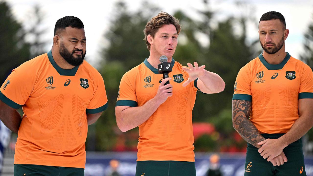 Michael Hooper with his teammates Quade Cooper and Taniela Tupou. Photo by Saeed KHAN / AFP
