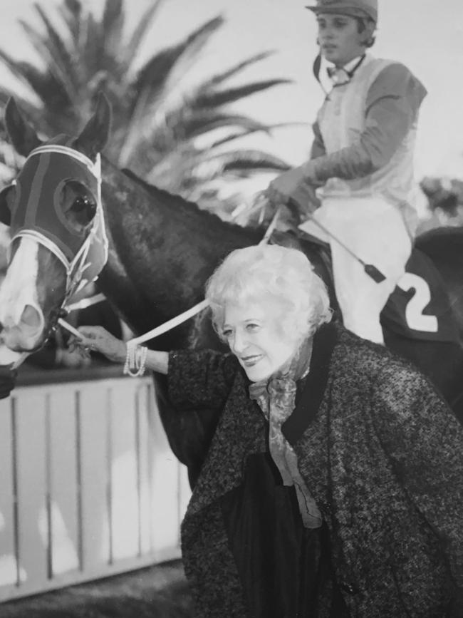 Enid Lindeman, bowed in later life with back problems, leading her namesake Miss Lindeman back to scale after a race win in the early 1970s.