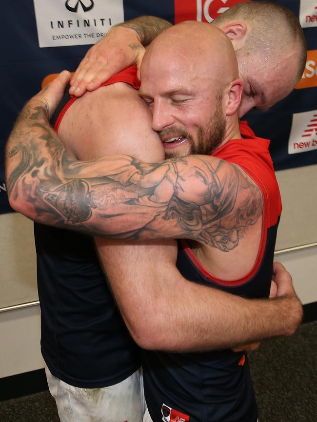 Jones and Gawn embrace in the rooms after the win. Picture: Getty