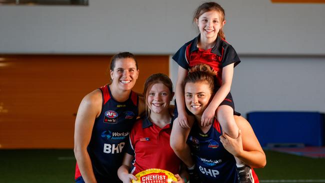 Crows players Chelsea Randall and Ebony Marinoff with Matilda and Katelyn. Picture: Matt Turner