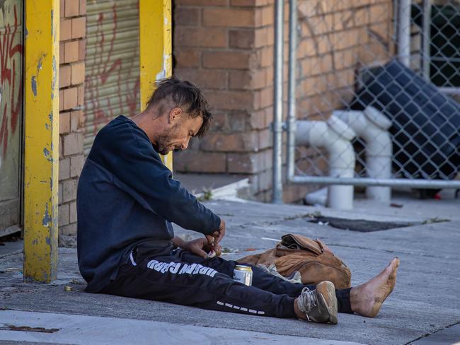 A man openly injects drugs into his leg in a thoroughfare alley near the North Richmond injecting room. Picture: Jason Edwards