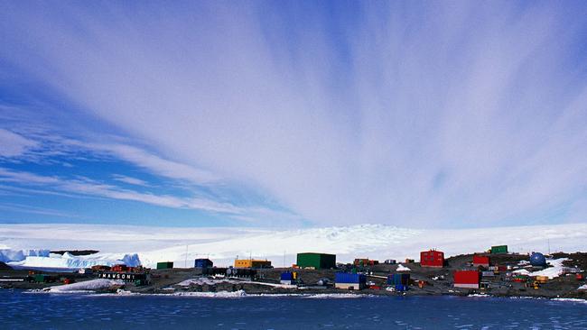 The Mawson base on a clear day with sirrus clouds streaming behind it. Picture: Colin Blobel