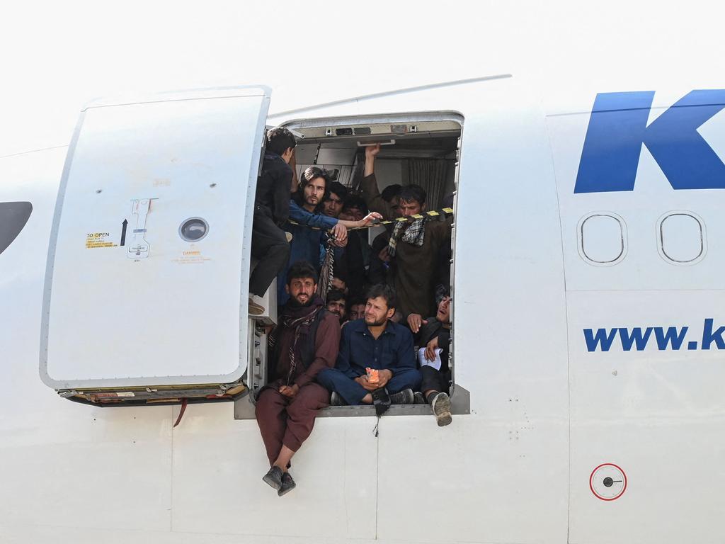 Afghan men are seen crammed into a plane sitting on the tarmac. Picture: Wakil Kohsar/AFP