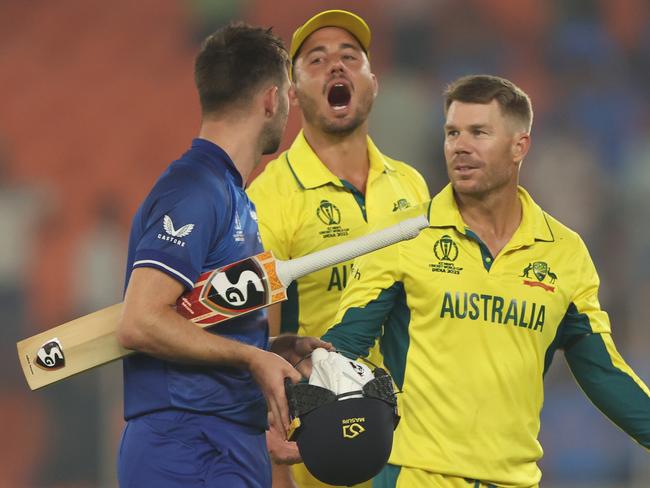 AHMEDABAD, INDIA - NOVEMBER 04: Mark Wood of England interacts with Marcus Stoinis and David Warner of Australia following the ICC Men's Cricket World Cup India 2023 between England and Australia at Narendra Modi Stadium on November 04, 2023 in Ahmedabad, India. (Photo by Robert Cianflone/Getty Images)