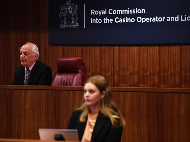 Commissioner Hon. Raymond Finkelstein AO QC (left) is seen during Victoria's royal commission into Crown Casino, in Melbourne, Wednesday, March 24, 2021. The inquiry will look at whether Crown has broken the law and if it is suitable to hold a gaming licence in Victoria. (AAP Image/James Ross) NO ARCHIVING