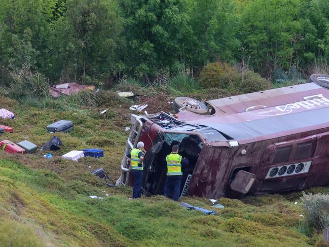 MELBOURNE, AUSTRALIA- SEPTEMBER 21 A school bus carrying 32 people has flipped on the Western Highway in Bacchus Marsh. Police are investigating the crash between a school bus and a truck that occured at around 3.15am. Picture: Brendan Beckett