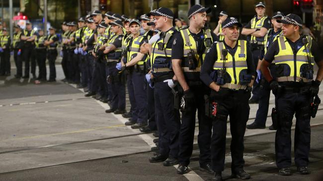 Police on the corner Flinders St and Swanston St on New Year’s Eve. Picture: Yuri Kouzmin