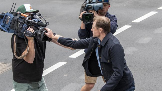 Daniel Muston, one of three men charged with performing the Nazi salute outside the Sydney Jewish Museum, scuffles with media outside Downing Centre Court. Picture: NewsWire / Simon Bullard